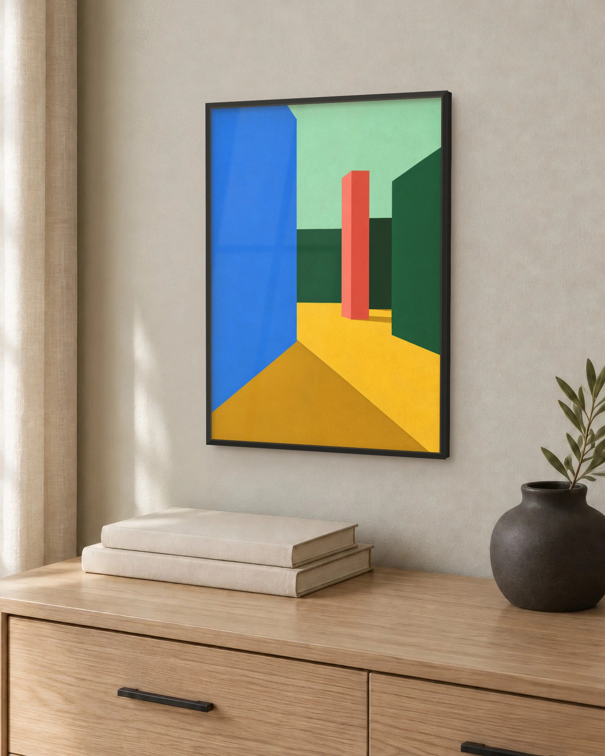 Affiche chambre architecture colorée encadrée en noir au-dessus d'une commode en chêne clair