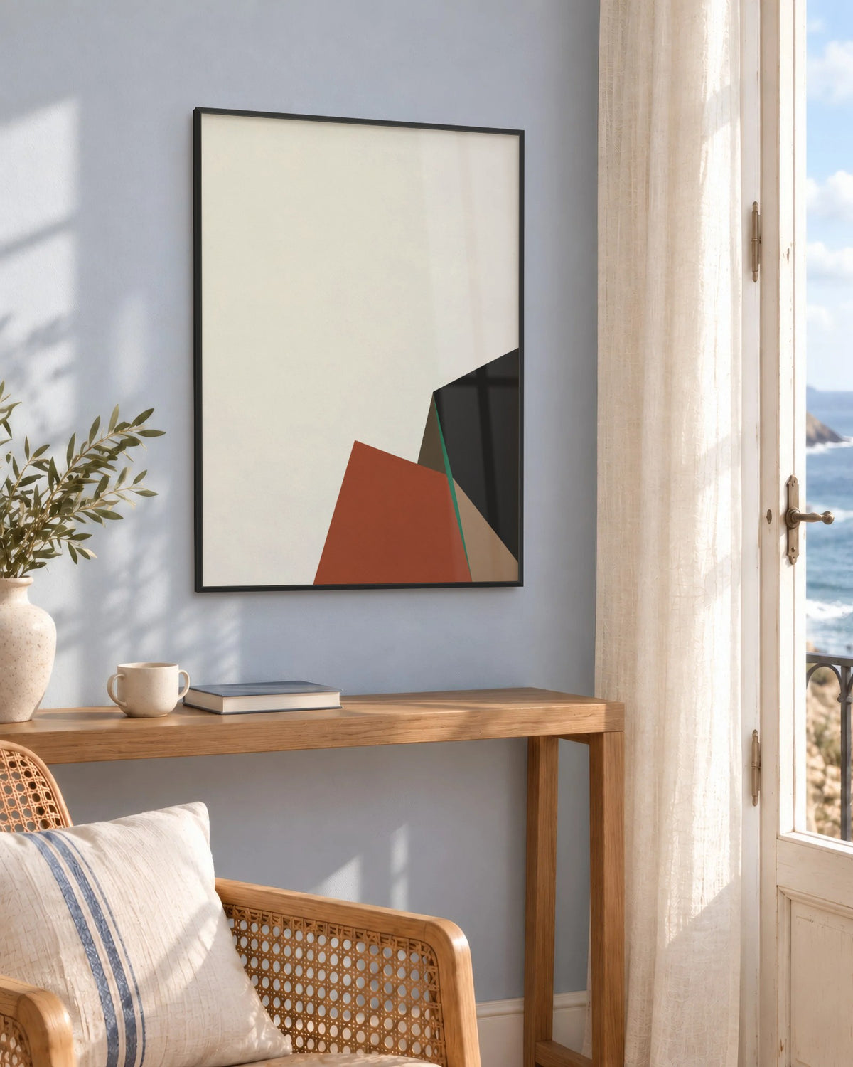 Affiche déco salon terracotta et beige en cadre noir sur un mur bleu, au-dessus d'une console